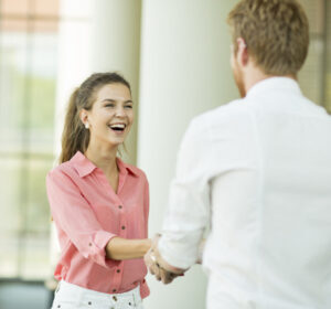 Young woman and man handshaking