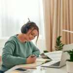 A woman works on her computer