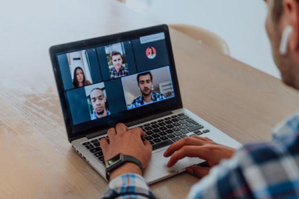 A man on a Zoom call with several others